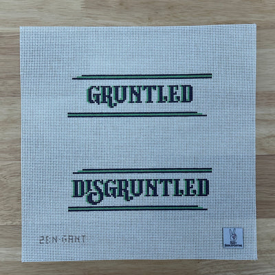 Needlepoint canvas with the words 'GRUNTLED' and 'DISGRUNTLED' written in green.